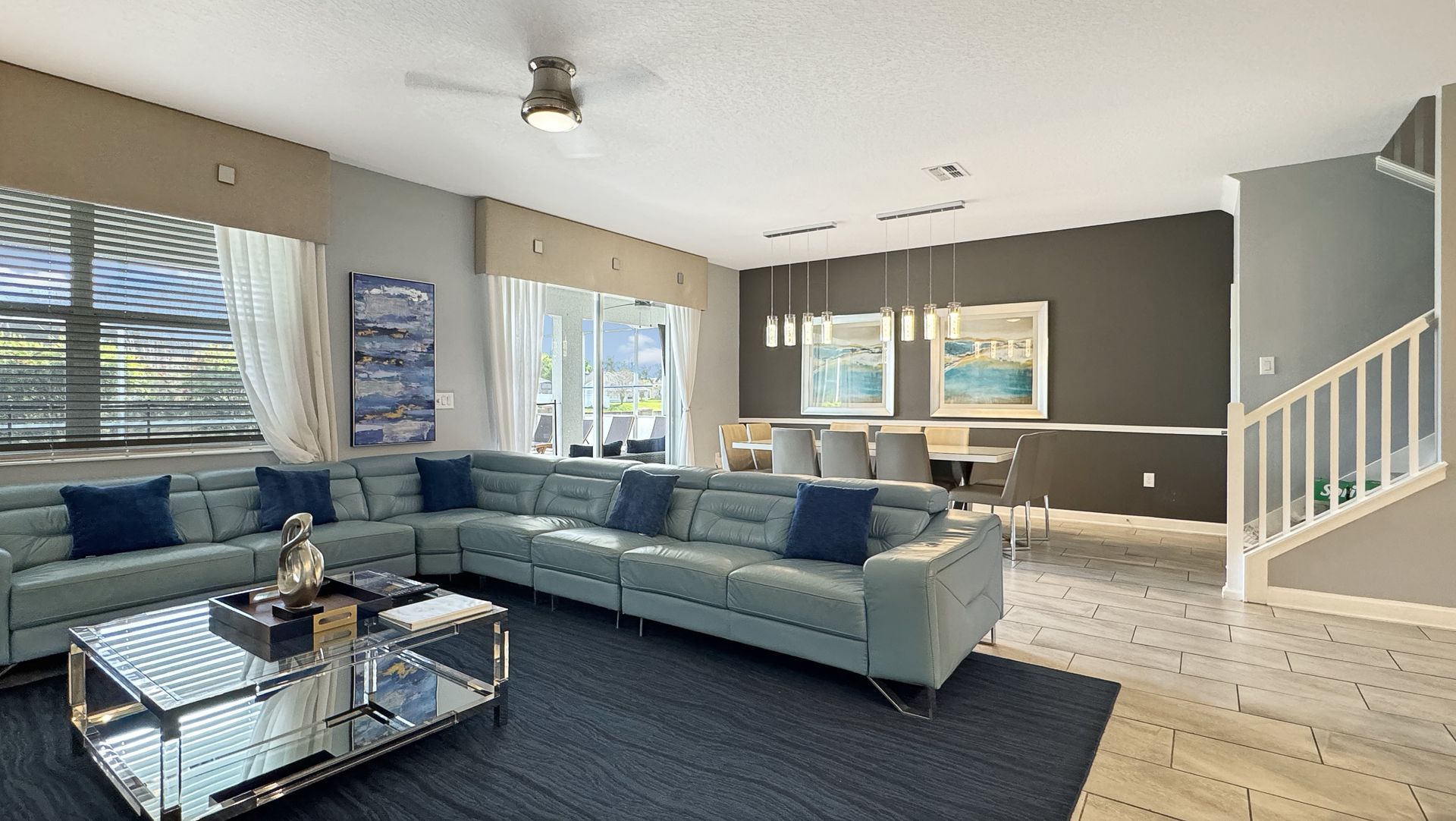 A living room with a large sectional couch and a coffee table