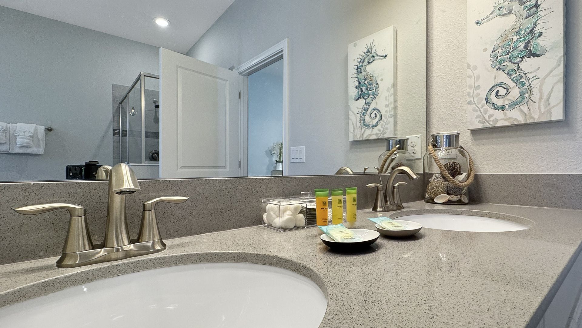 A bathroom with two sinks and a large mirror.