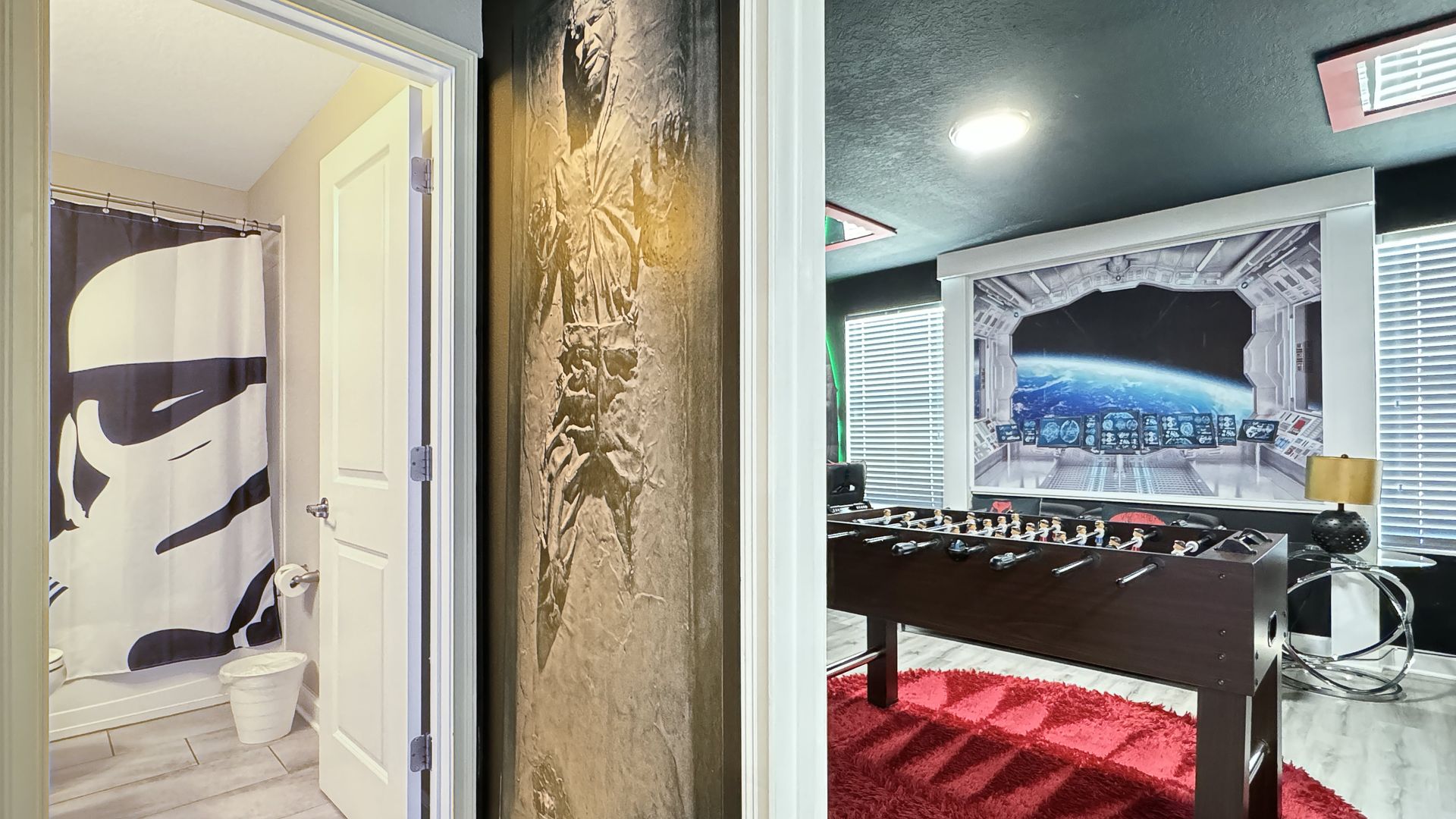 A bathroom with a storm trooper shower curtain and a game room with a foosball table.