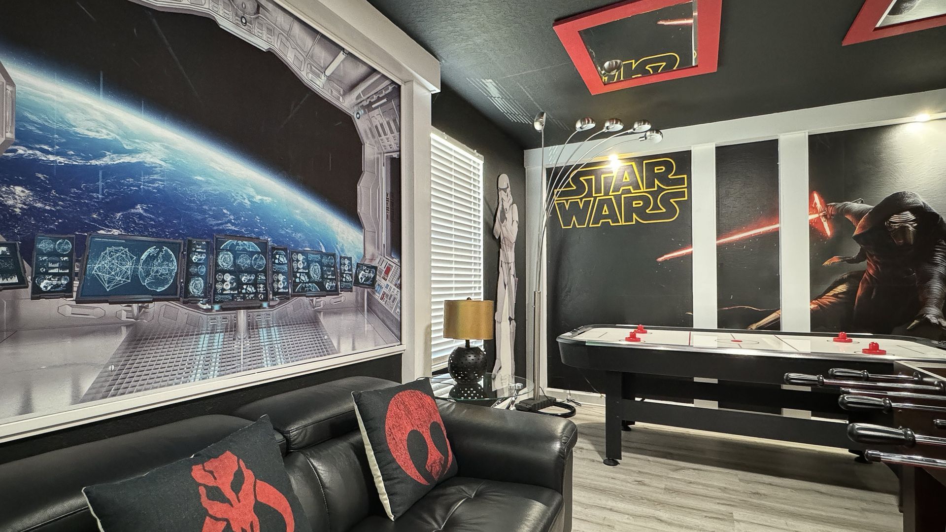 A living room with a pool table and a couch.