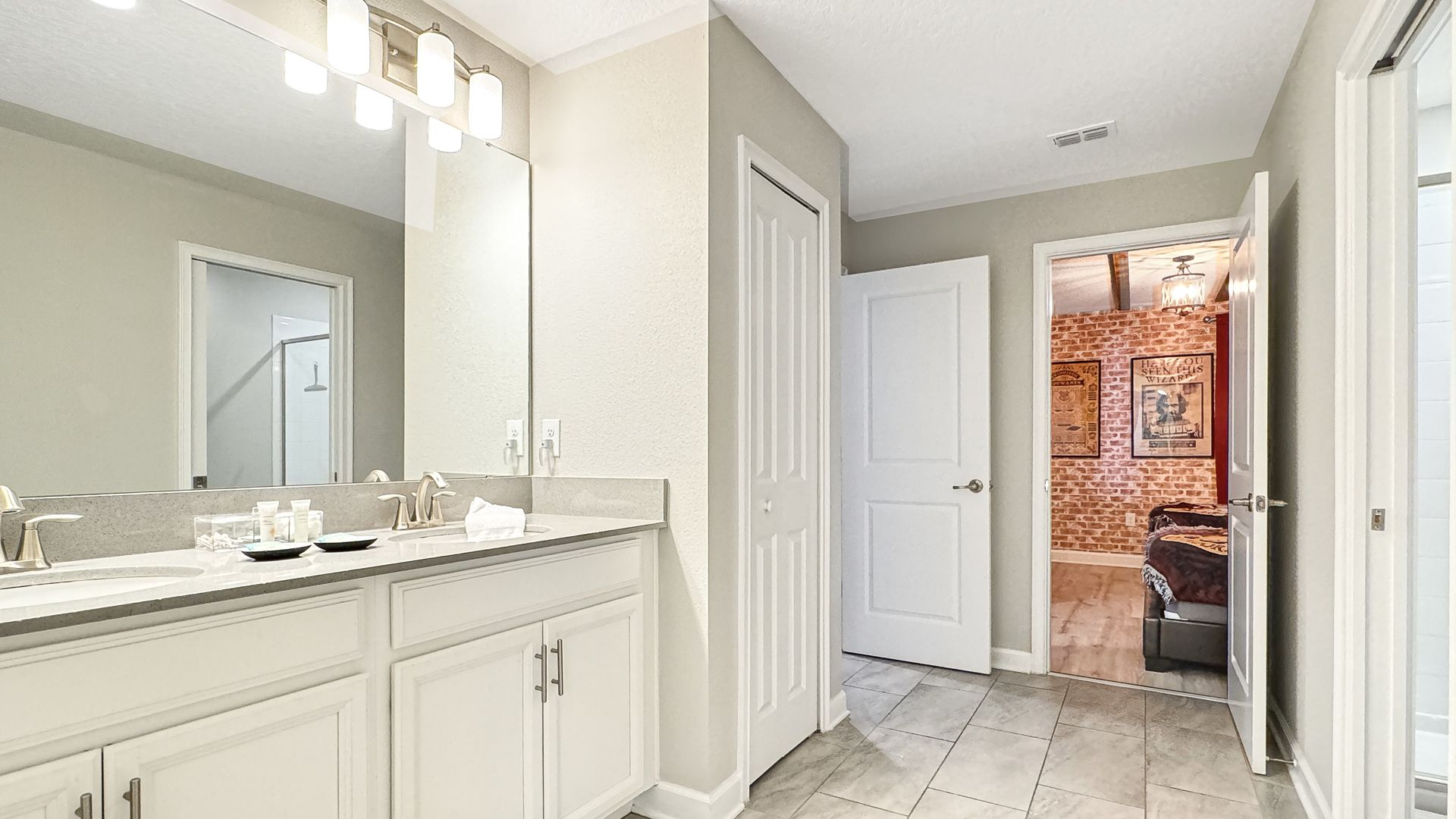 A bathroom with two sinks and a large mirror.