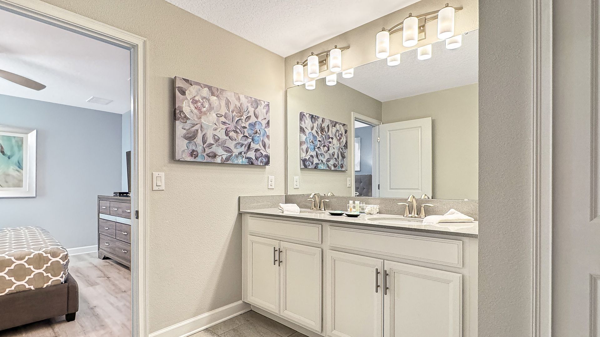 A bathroom with two sinks and a large mirror.