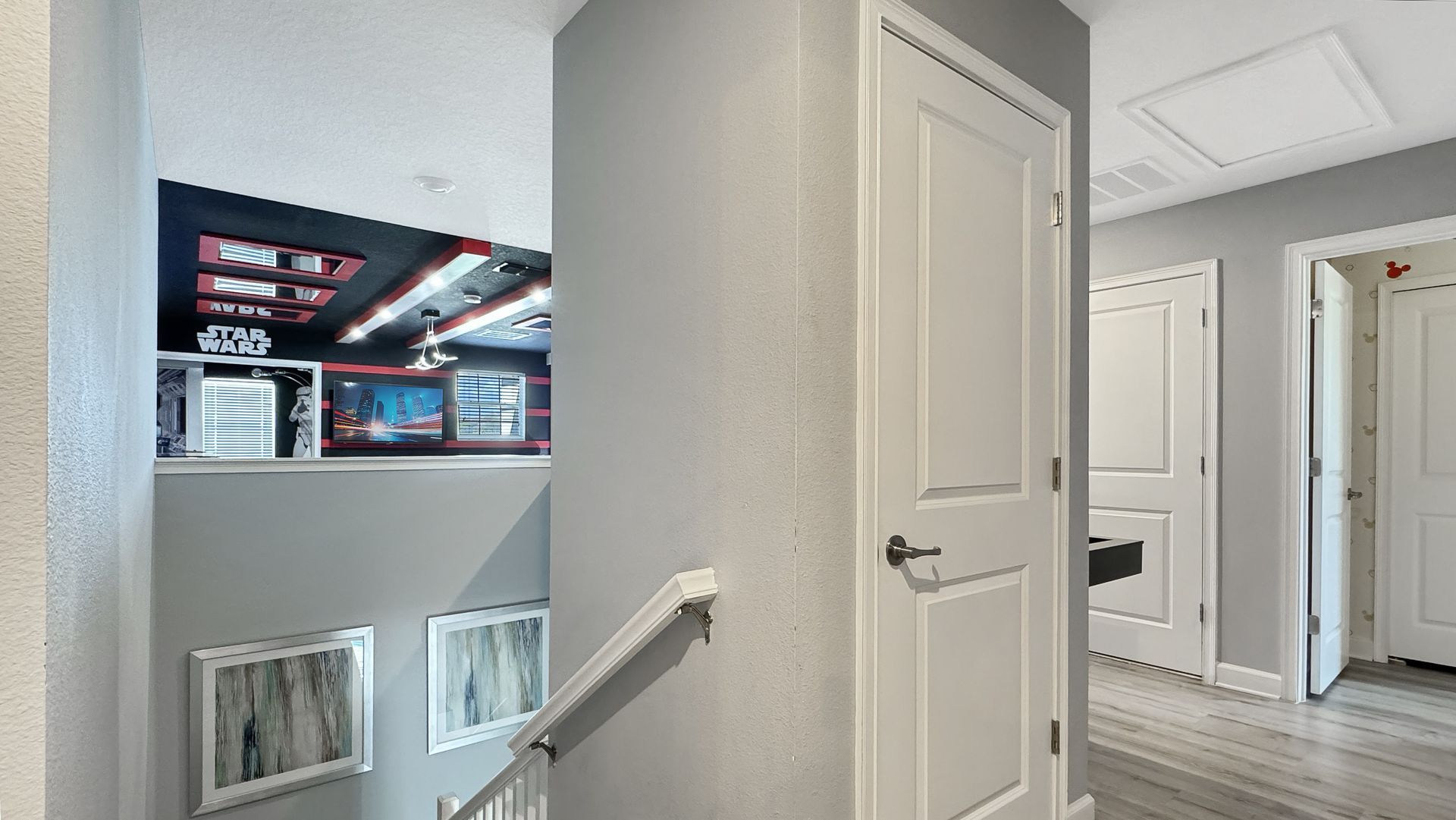 A hallway with stairs leading up to the second floor of a house.
