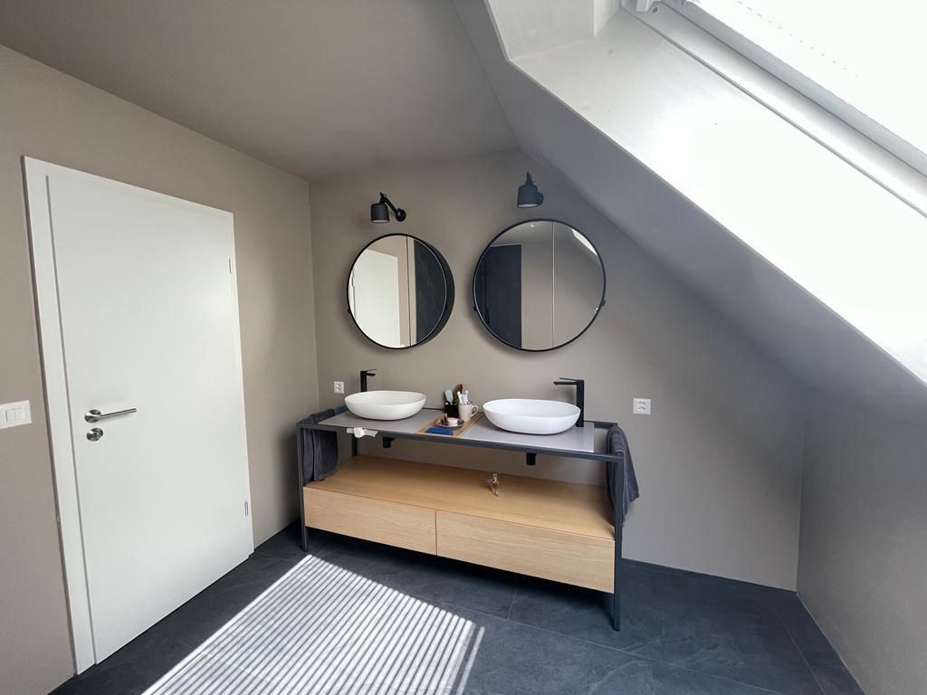 Ein Badezimmer mit zwei Waschbecken und zwei Spiegeln.