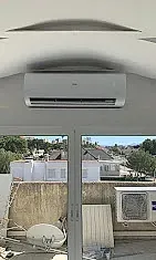 Una habitación con una ventana y un aire acondicionado en el techo.