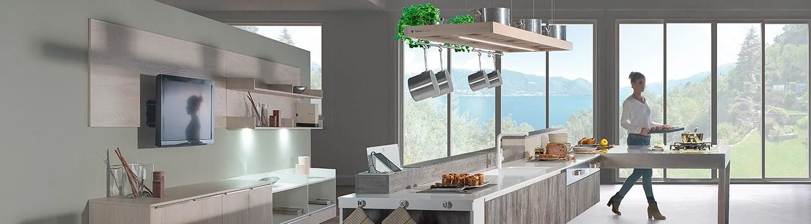 Un hombre está de pie en una cocina frente a una gran ventana.