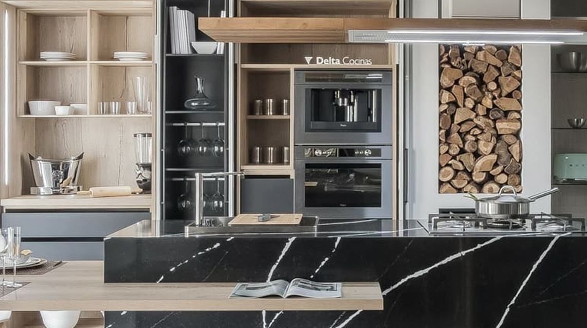 Una cocina con encimera negra, electrodomésticos de acero inoxidable, estantes de madera y una estufa.