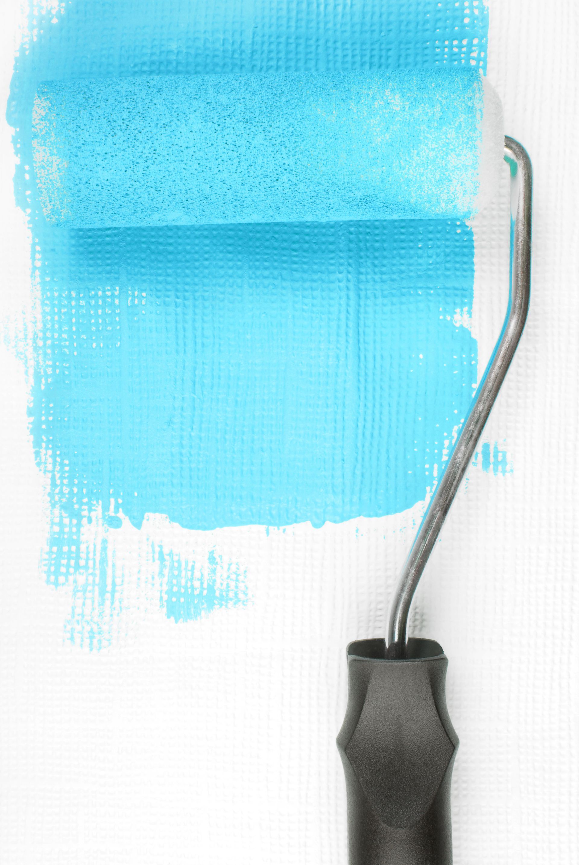 Rouleau à peinture appliquant de la peinture bleu clair sur une surface blanche.