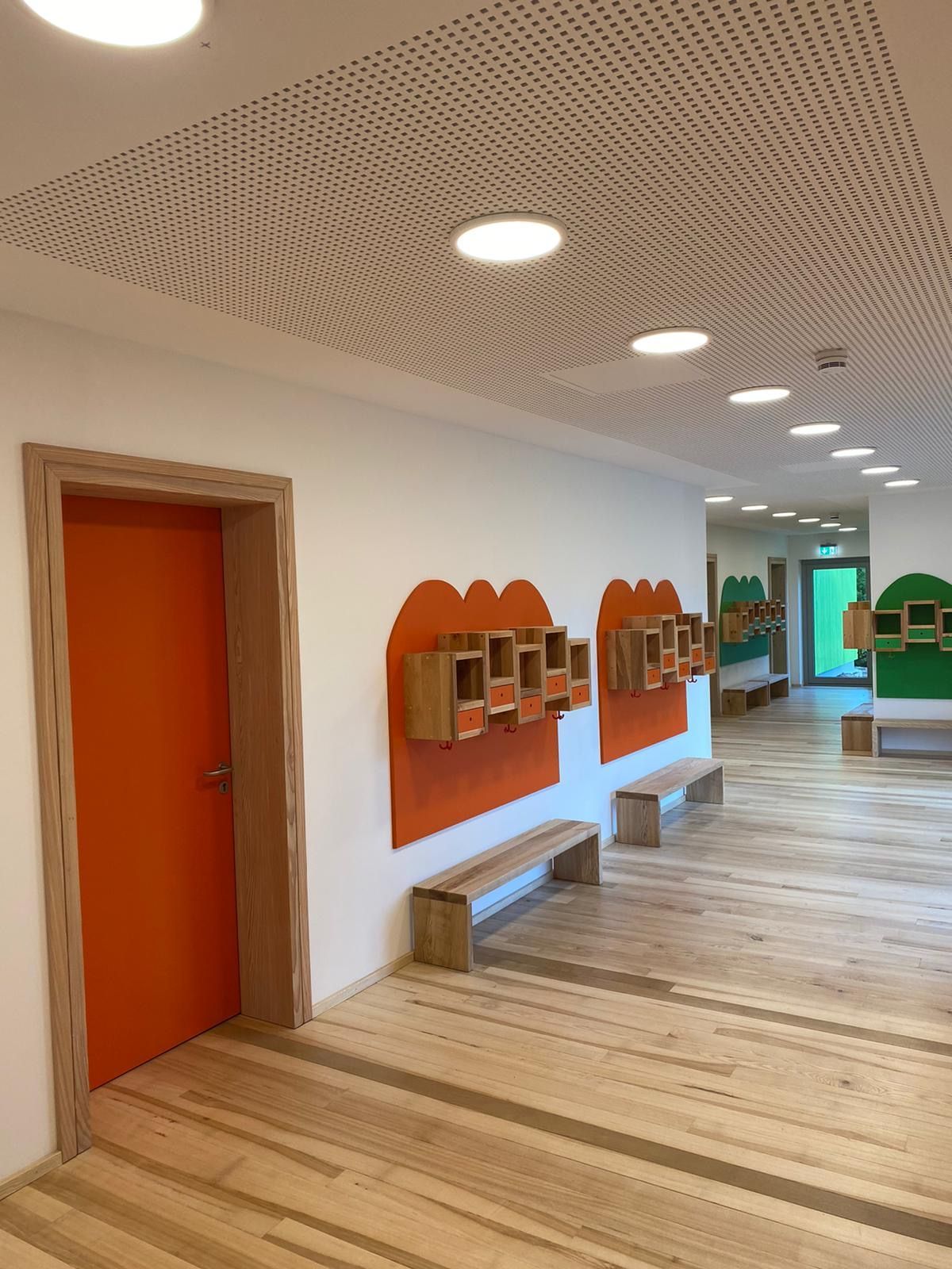 Flur Kindergarten mit Kästen und Bänken vor einer Tür