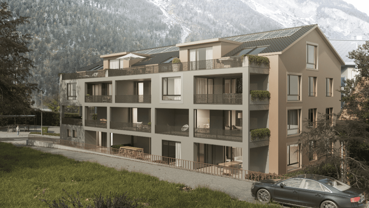 Ein großes Mehrfamilienhaus mit einem davor geparkten Auto.