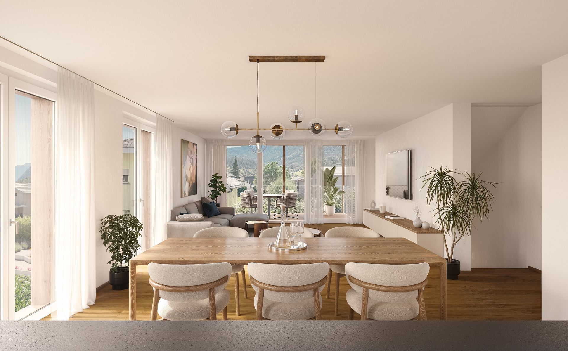 Modernes Wohnzimmer mit Esstisch, Sofa und Bergblick.