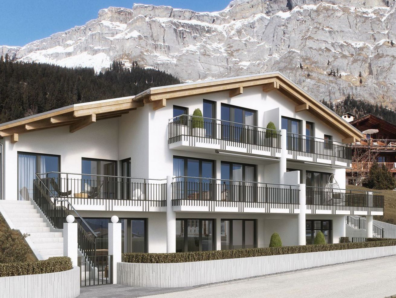 Ein großes weißes Haus mit einem Berg im Hintergrund