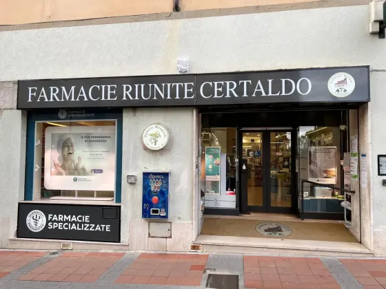 Vetrina della farmacia con insegna nera recante la scritta