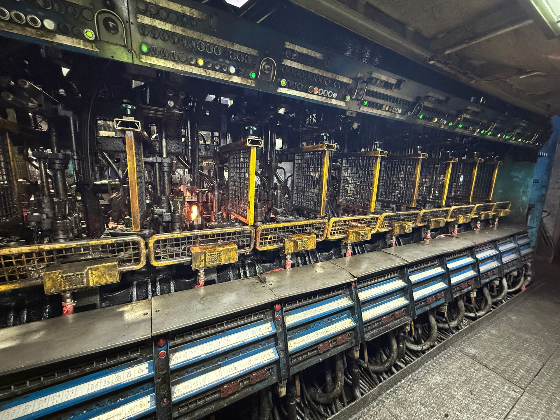 A complex machine with numerous compartments and wiring, likely industrial, with glowing orange elements.