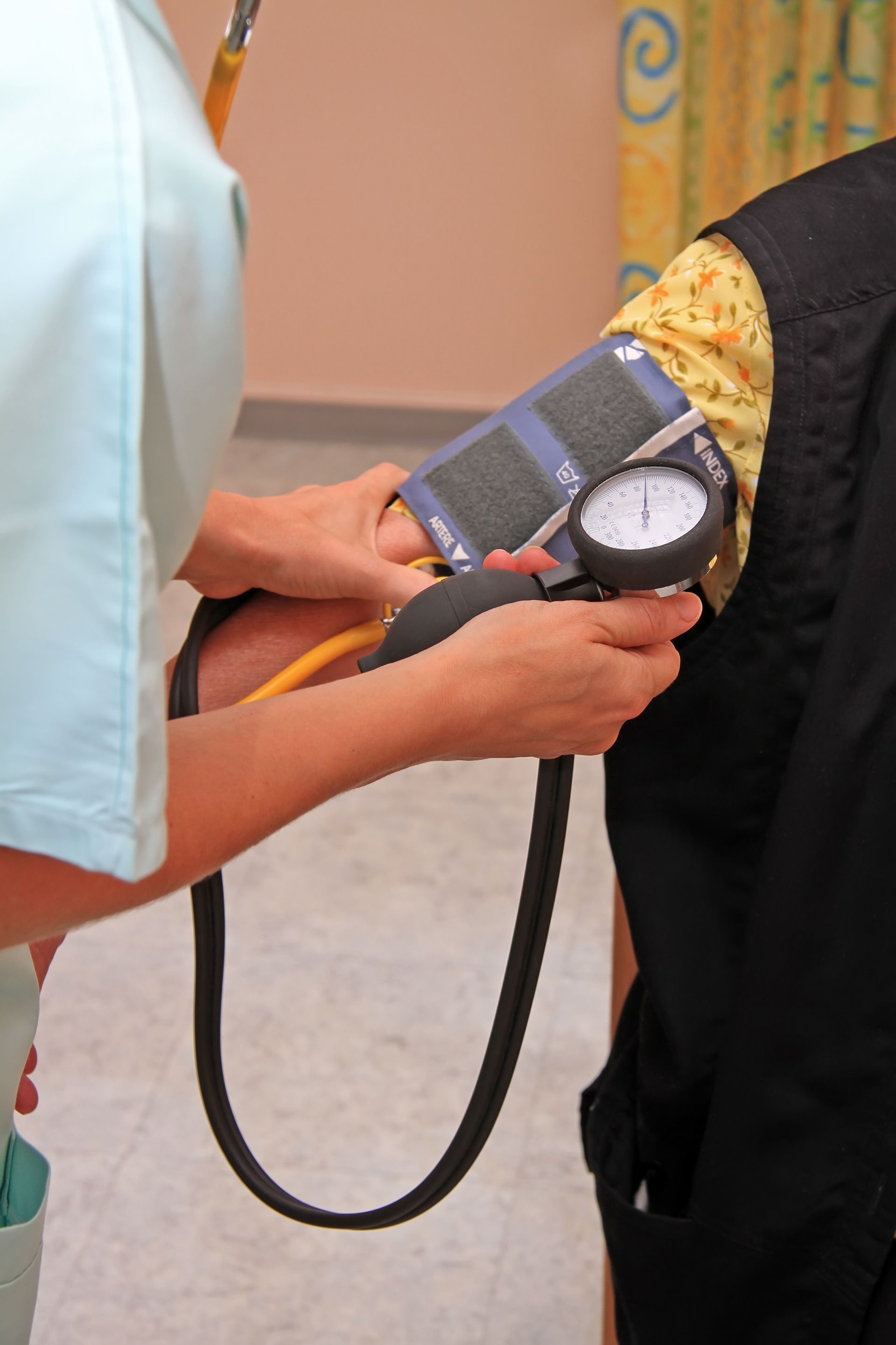 Un professionnel de la santé prend la tension artérielle d'une personne à l'aide d'un stéthoscope et d'un brassard.