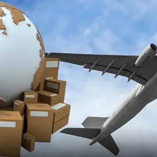 Un avión vuela sobre una pila de cajas de cartón y un globo terráqueo.