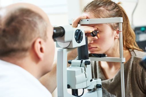 Una mujer está siendo examinada por un oftalmólogo.