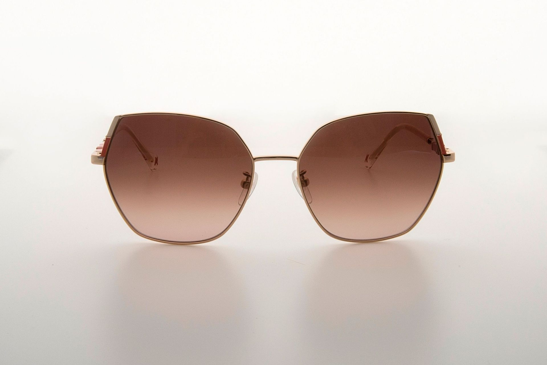 Un par de gafas de sol están sobre una superficie blanca.