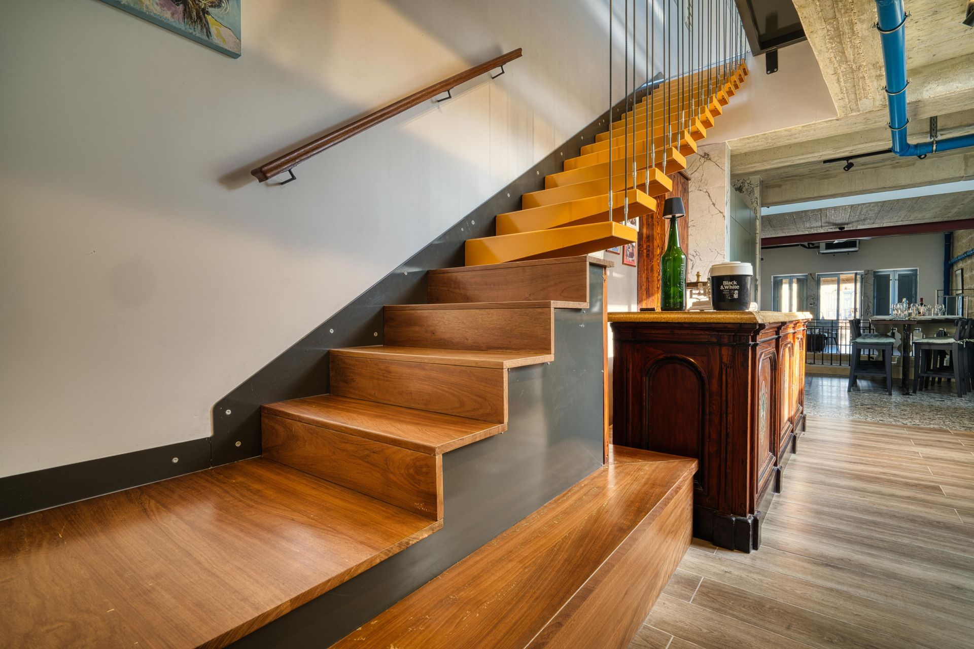Floating staircase and carved antique bar