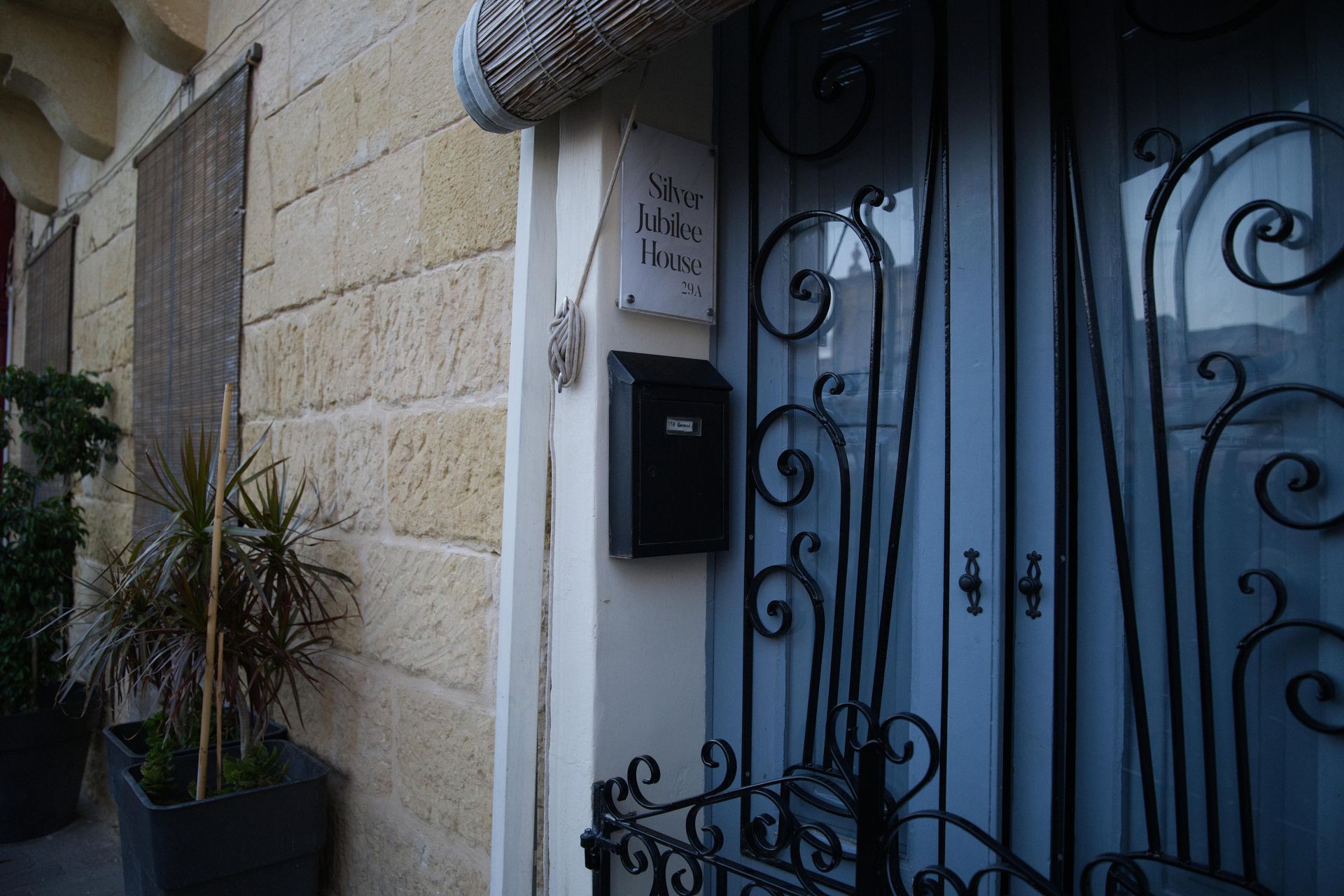 Front door with Silver Jubilee name plaque and wrought iron