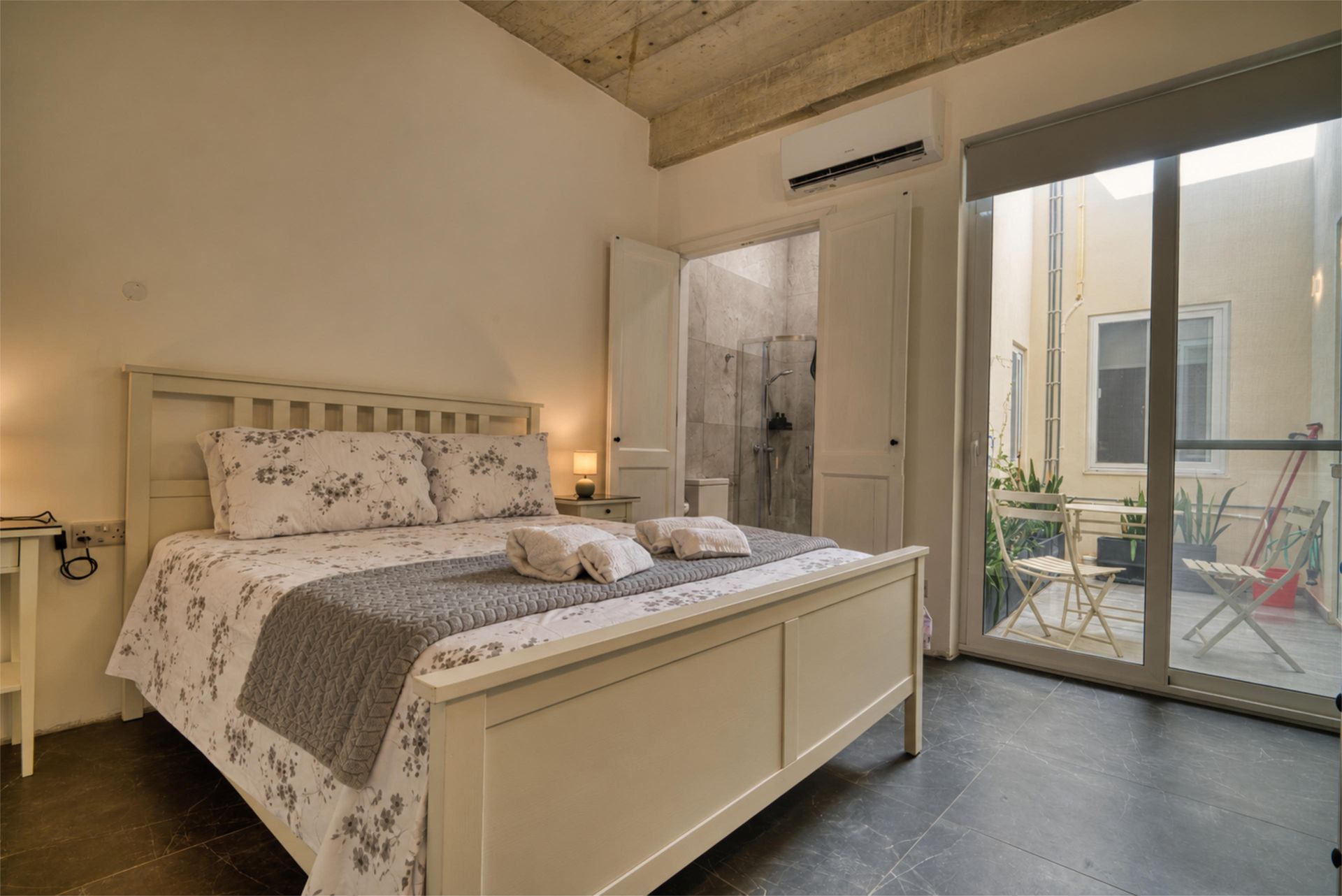 Main bedroom with balcony doors and en-suite bathroom