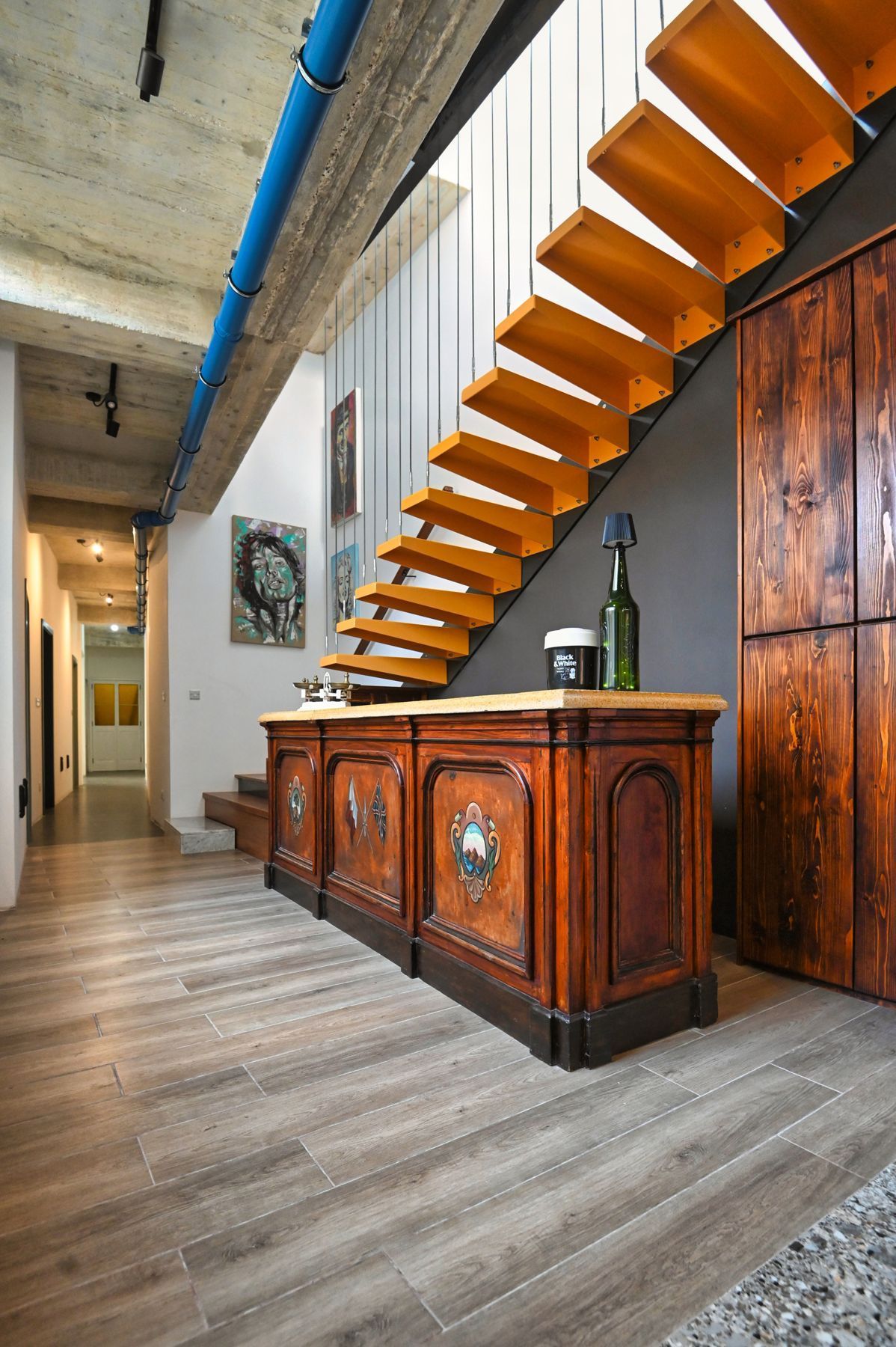 Oak staircase above the antique bar