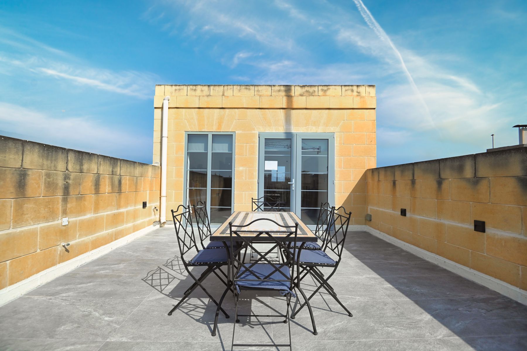 Outdoor dining table on the private roof terrace
