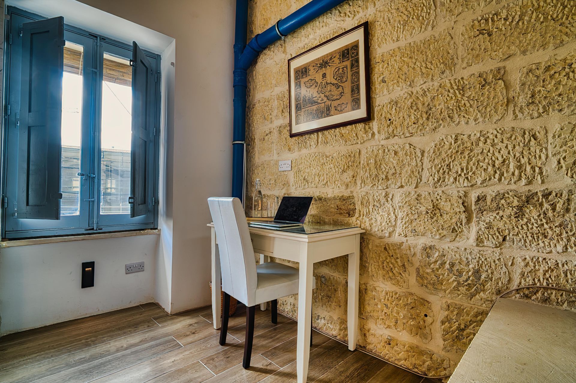 Study desk by a stone wall and window