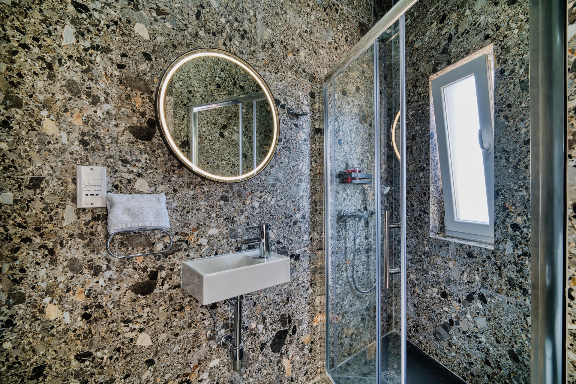 Terrazzo shower room with round mirror
