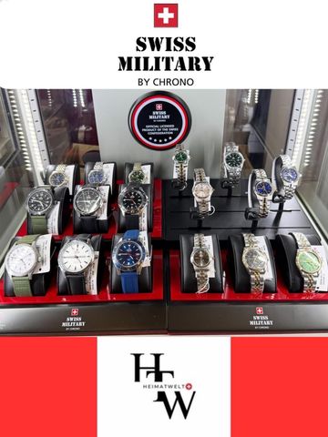 Schweizer Militäruhren in einem Geschäft ausgestellt, rote und schwarze Akzente, Glasvitrine.