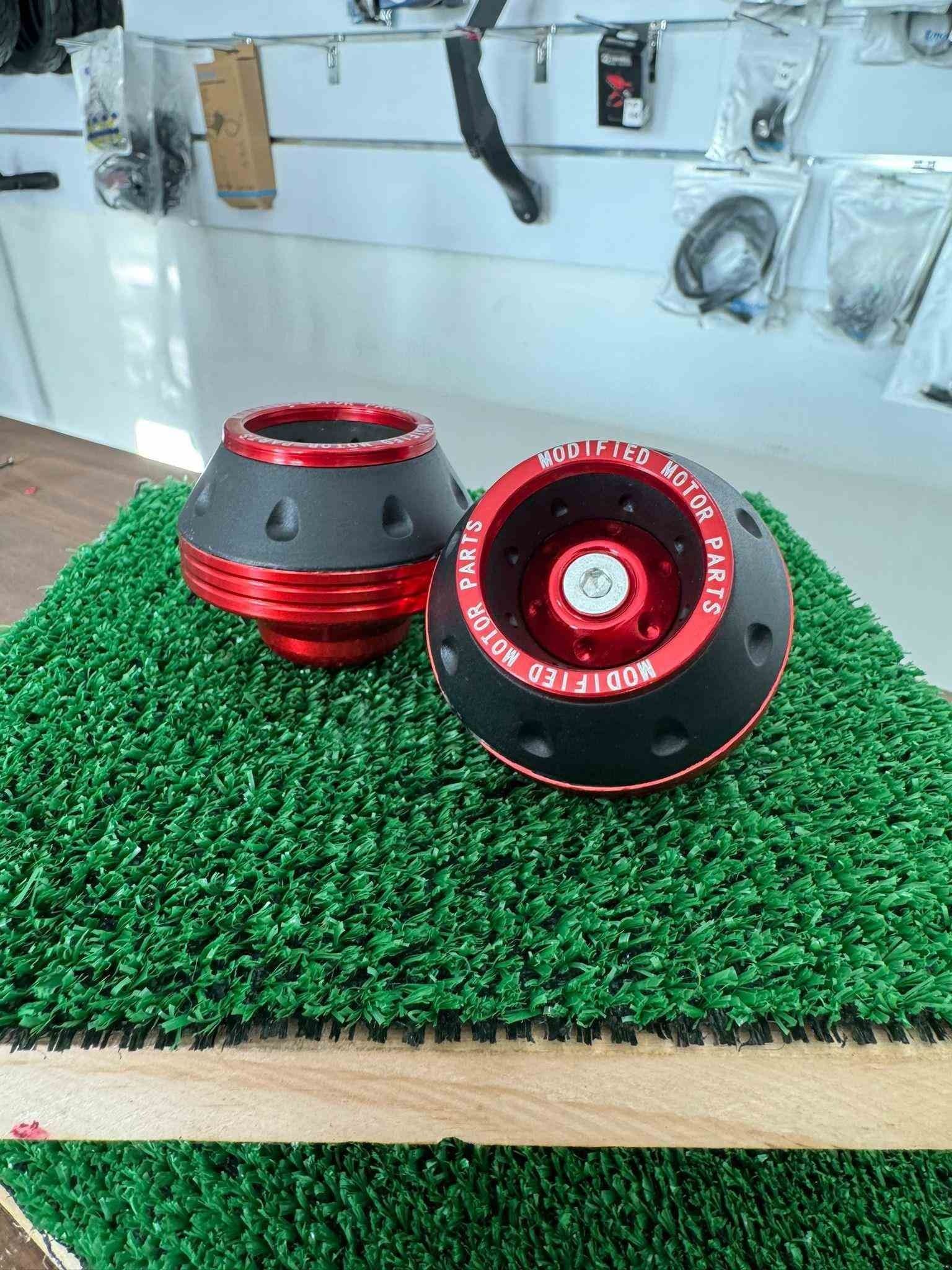 Un par de ruedas rojas y negras están colocadas encima de una mesa.