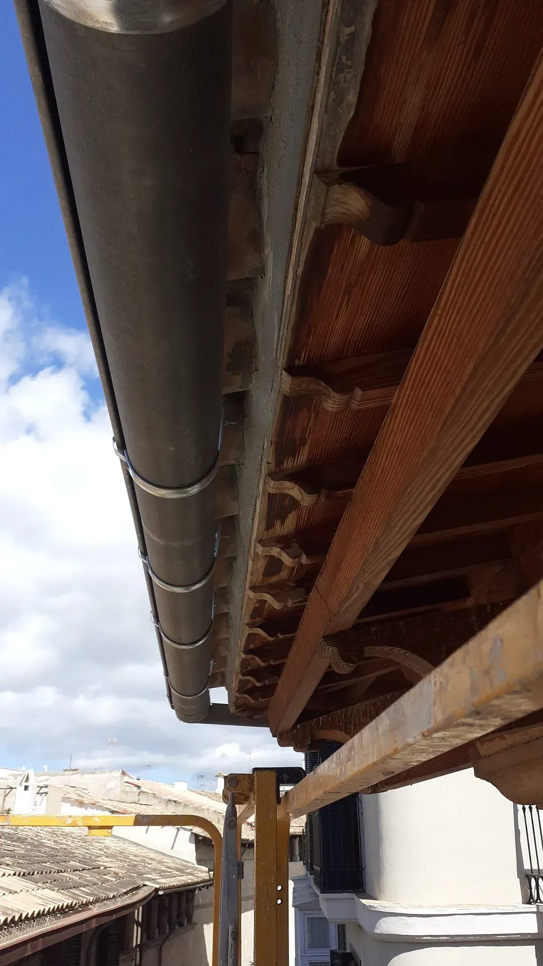 Una canaleta cuelga del techo de un edificio.