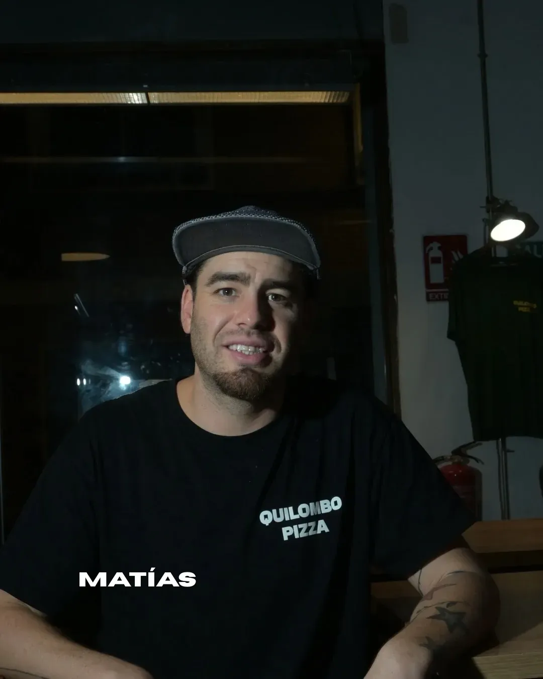 Hombre con gorra y camisa negra que dice