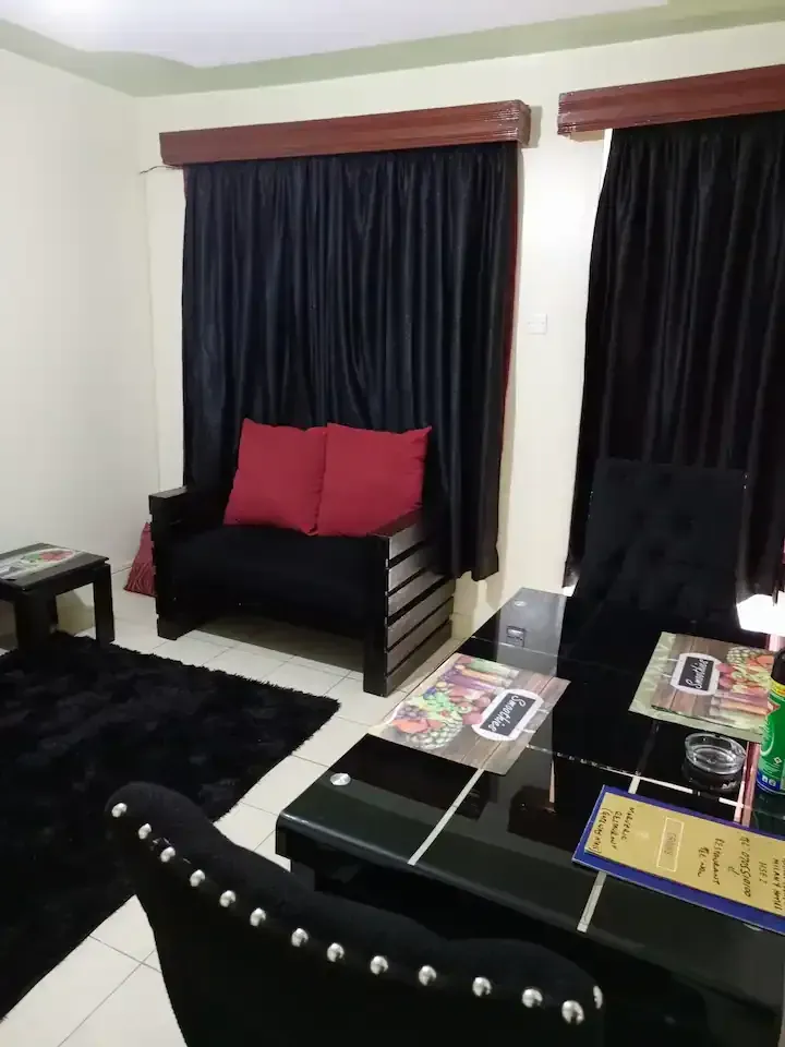 A living room with a couch and a table with a menu on it