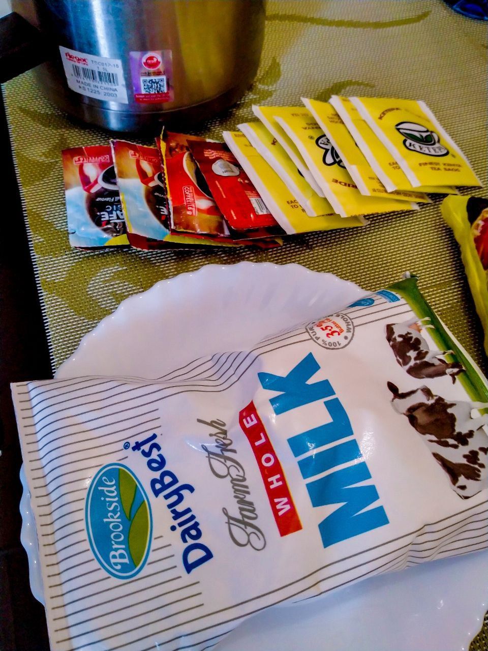 A bag of dairy best whole milk is on a white plate