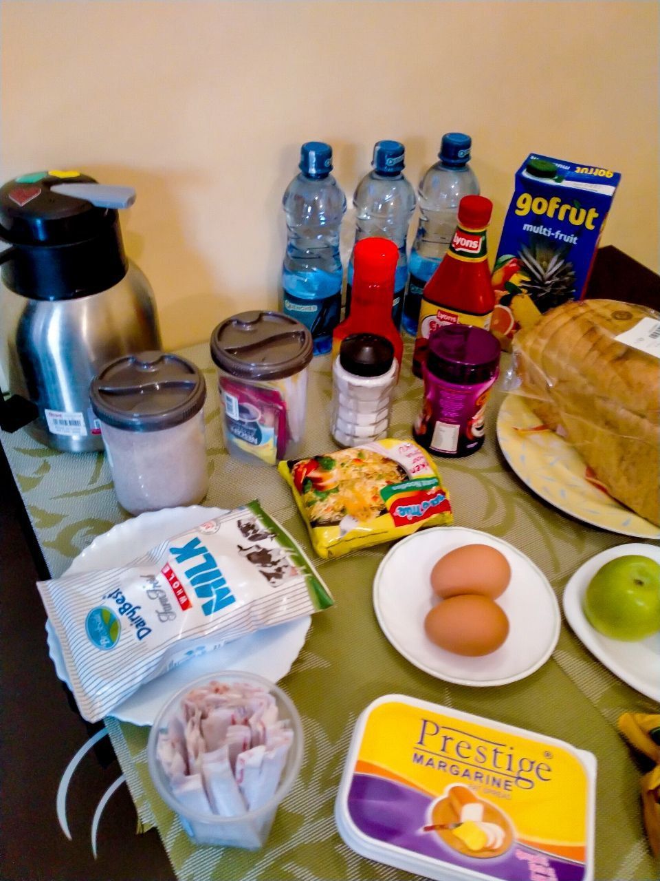 A table full of food including prestige butter
