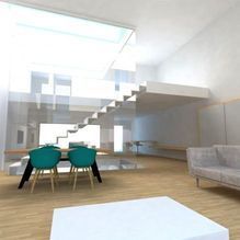 Una sala de estar con sofá, mesa, sillas y escaleras.