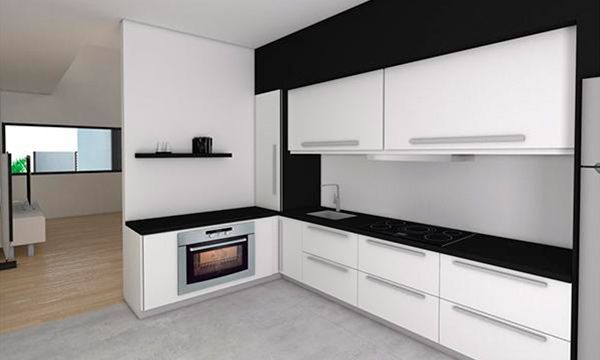 Una cocina con gabinetes blancos y encimeras negras.