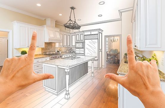 Una persona está enmarcando un dibujo de una cocina con sus manos.