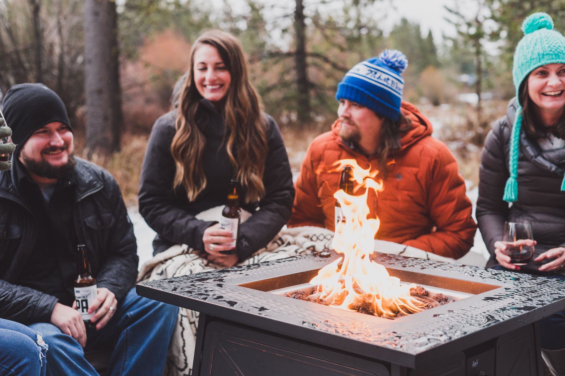 people sitting around a firepit during apres ski in Bend