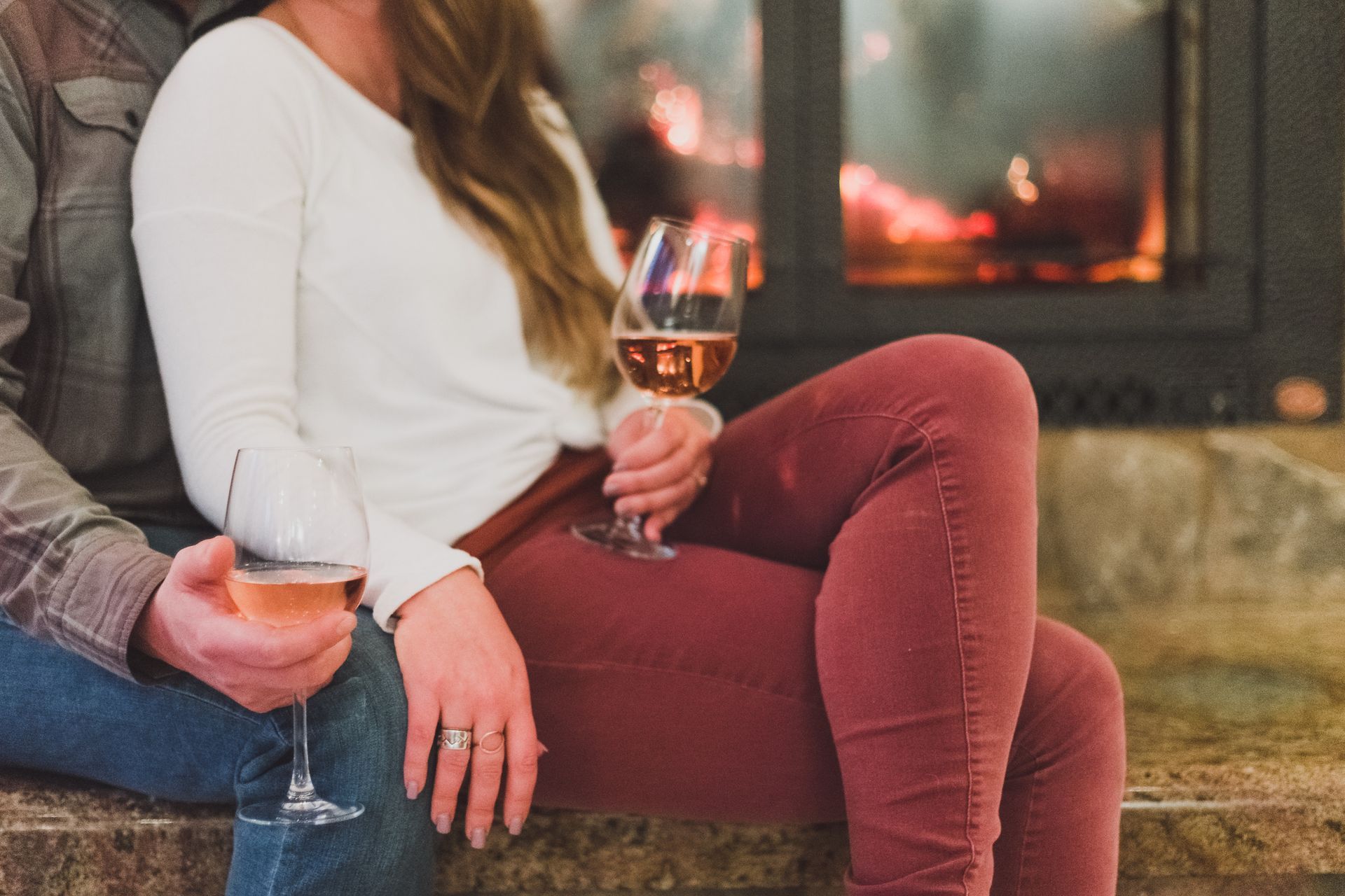 couple relaxing by a fire sipping wine during a romantic winter getaway in Central Oregon