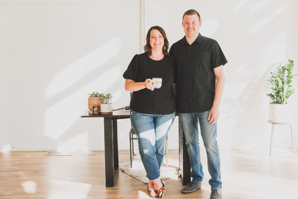 couple sipping out of one tiki drink with two straws to represent the best fall date night ideas in Bend, Sunriver, and Redmond