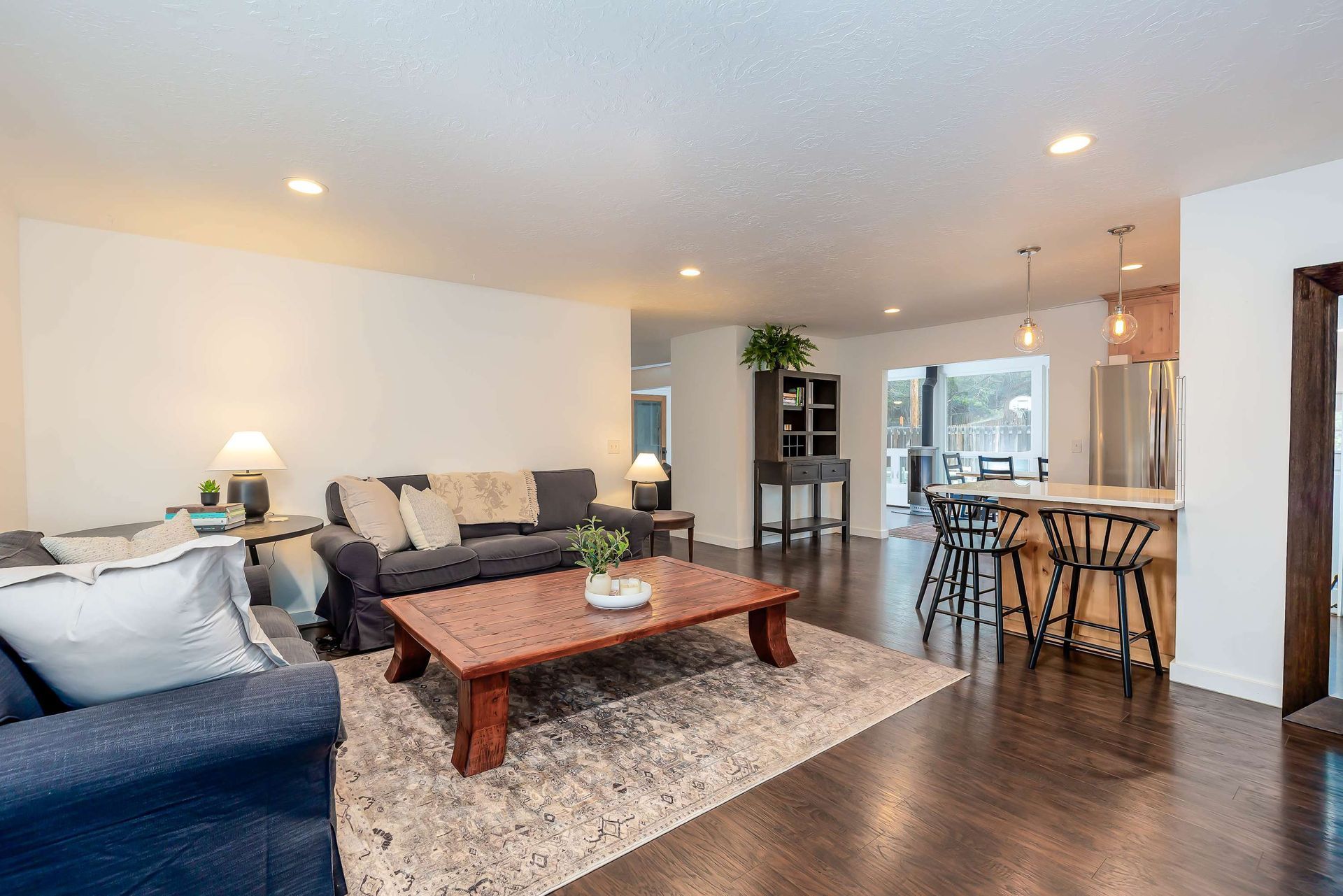 Open concept living room with view of kitchen and dining at 15th Avenue Getaway vacation rental in Bend