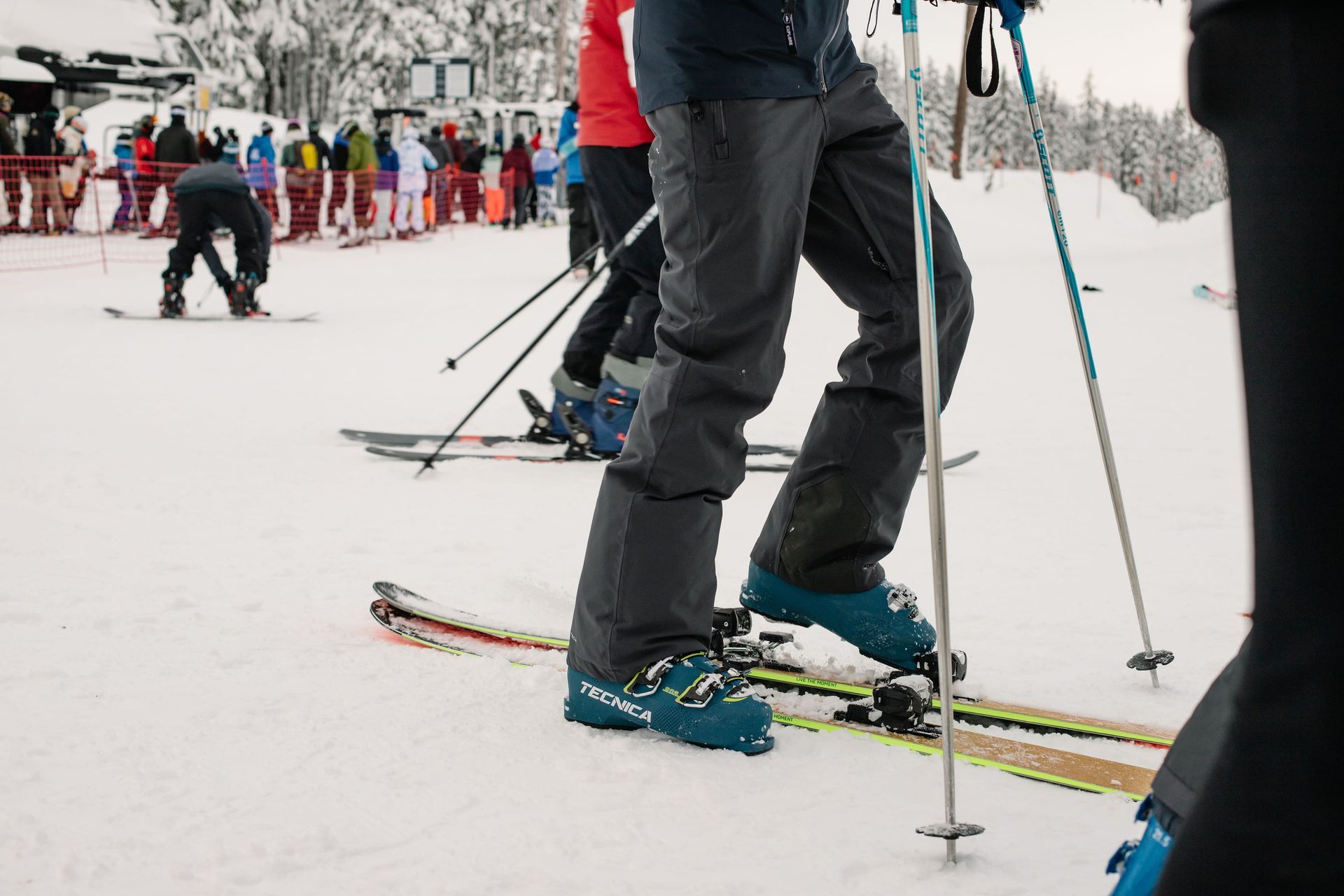 skier putting on boots at Mt. Bachelor ski resort just outside Bend, Oregon