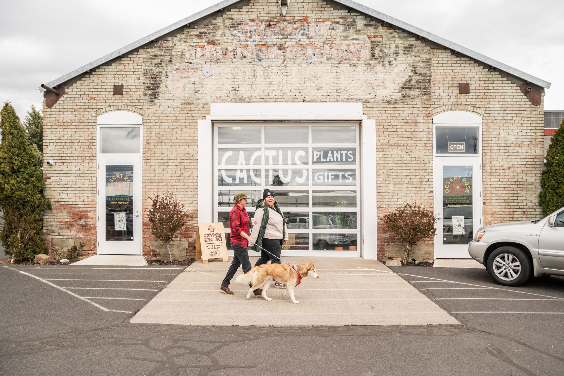 Two shoppers in front of Desert Rose Cactus Lounge  in the Old Iron Works on Thanksgiving weekend in Bend