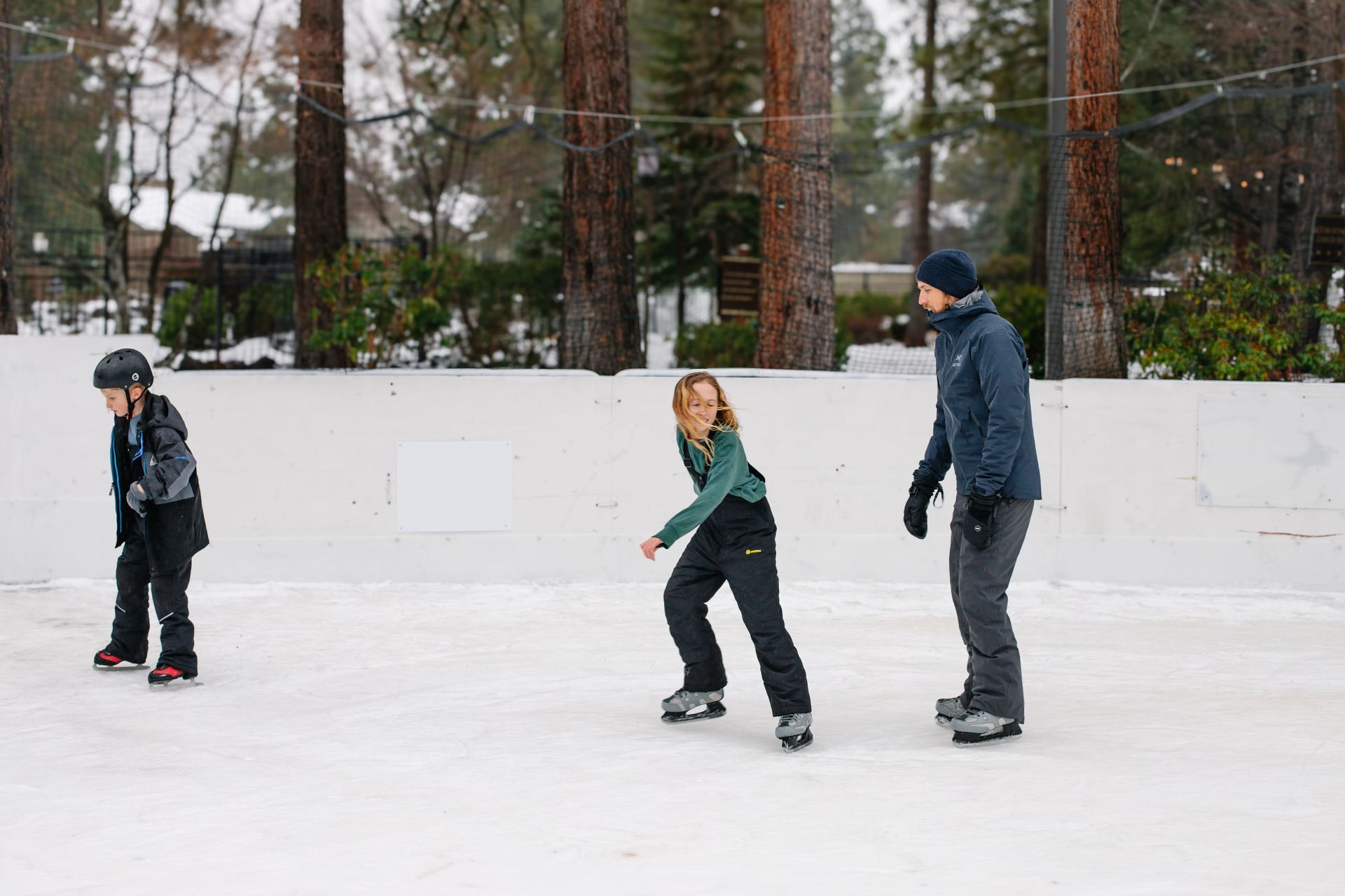 People ice skating during a family winter weekend itinerary in Bend
