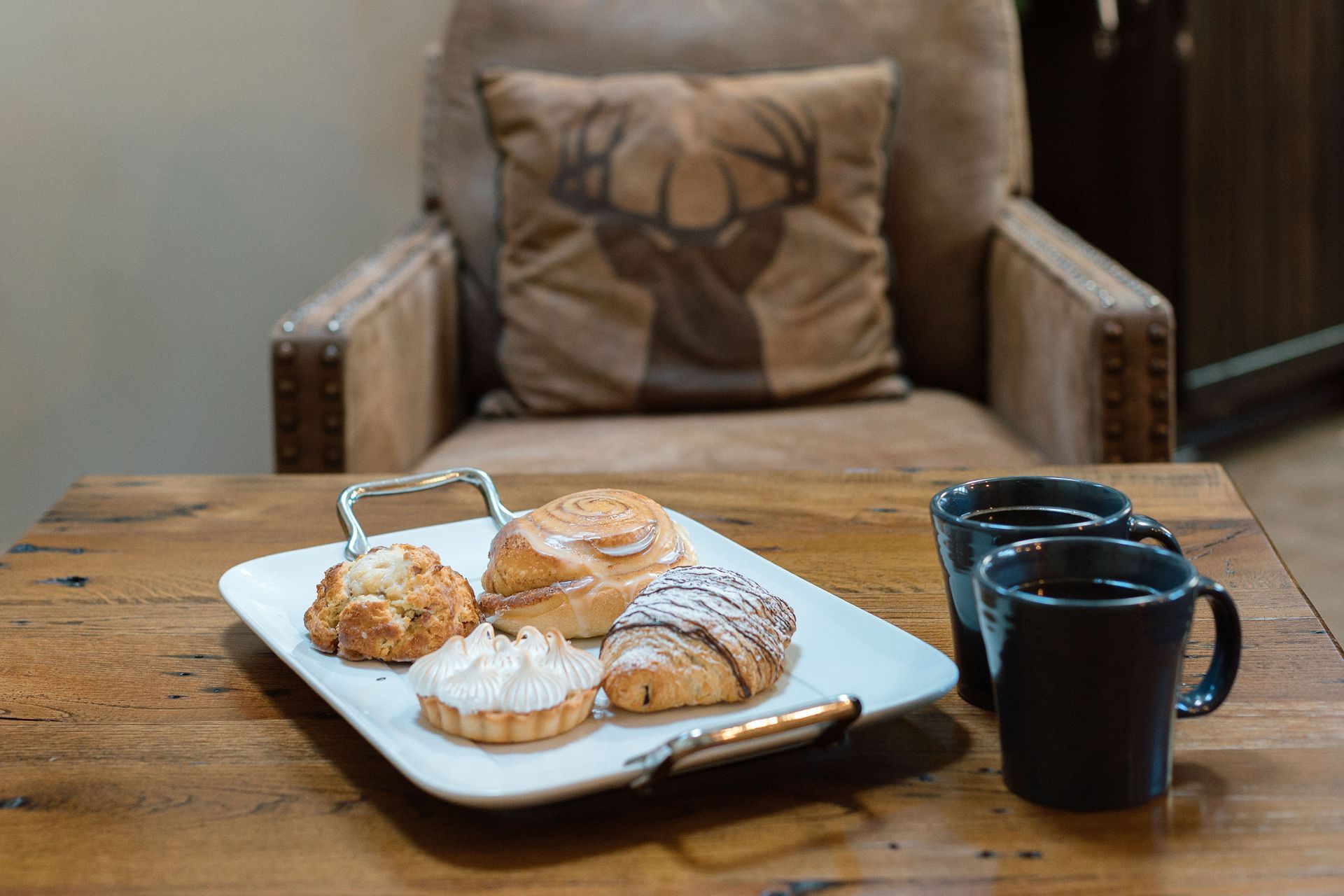 a wicker tray filled with food and a book on a bed .