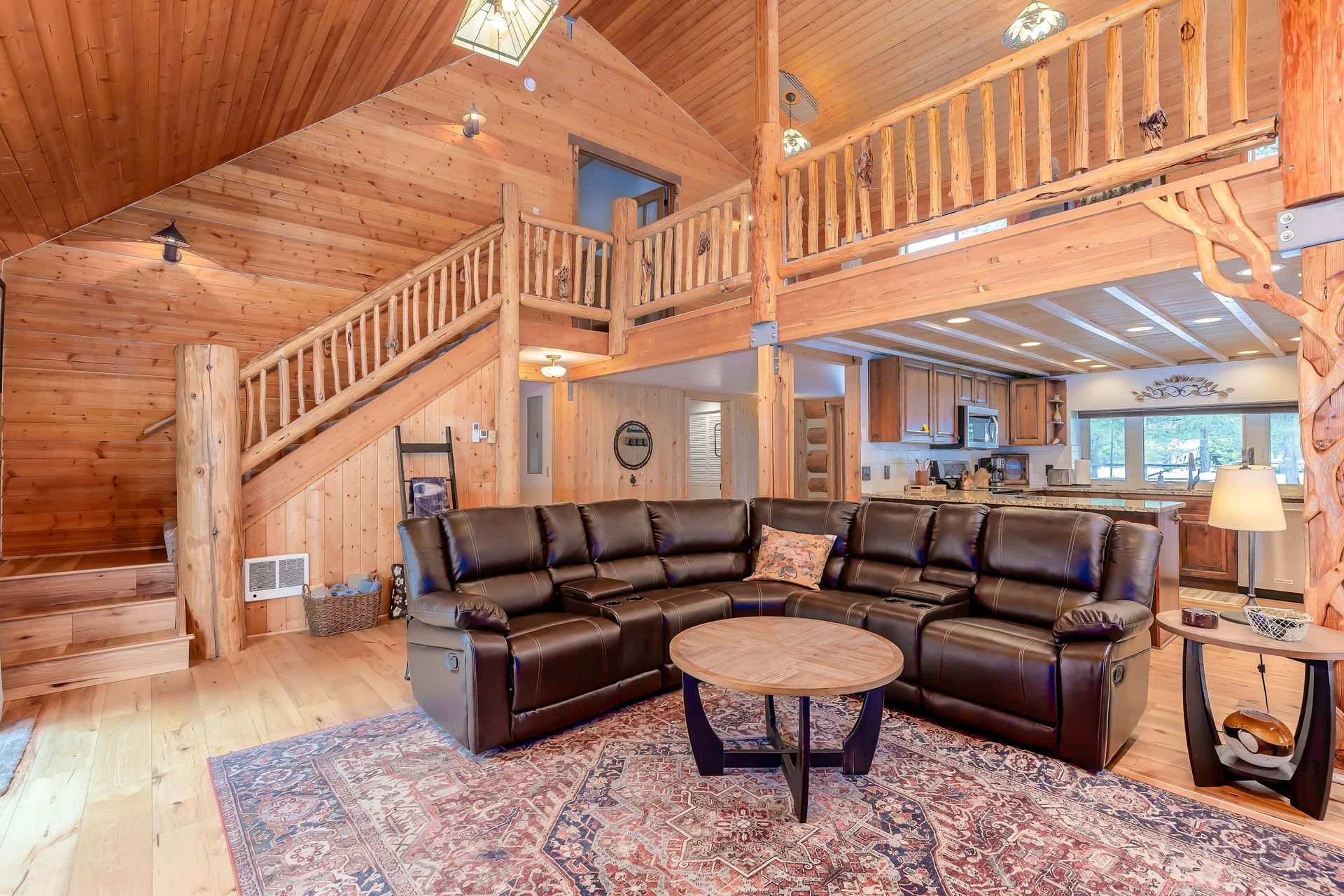 the living room and kitchen of Woodcarver's Cabin, a cabin style vacation rental in Sunriver