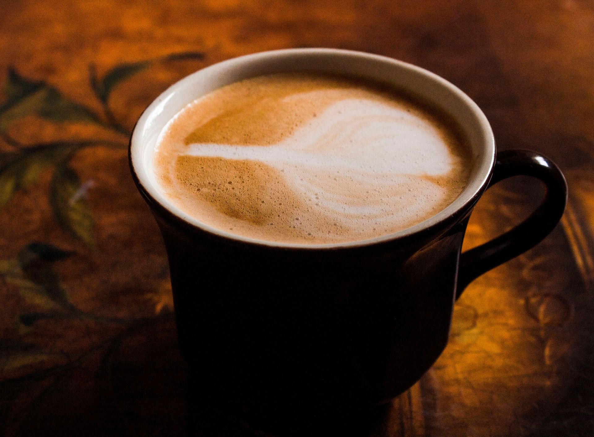 Sisters Coffee bags in front of a pumpkin spice latte