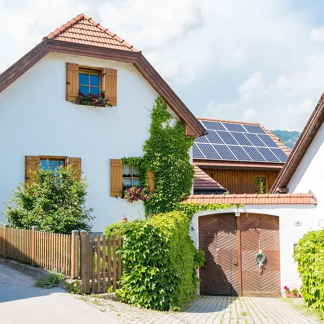 Una casa blanca con paneles solares en el techo